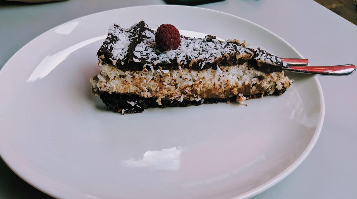 slice of vegan coconut and chocolate pie on a white plate in krakow