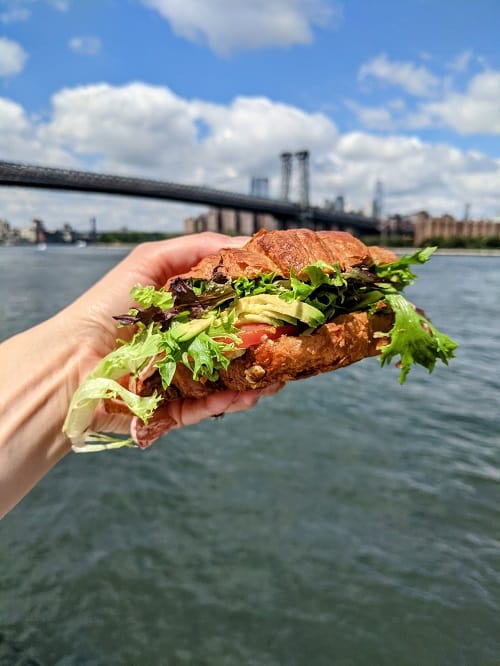 terms of endearment NYC vegan croissant sandwich overlooking brooklyn bridge