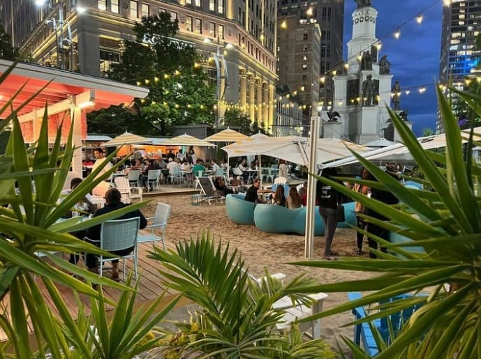 detroit's campus martius beach area filled with umbrella tables on a man made beach in the summer