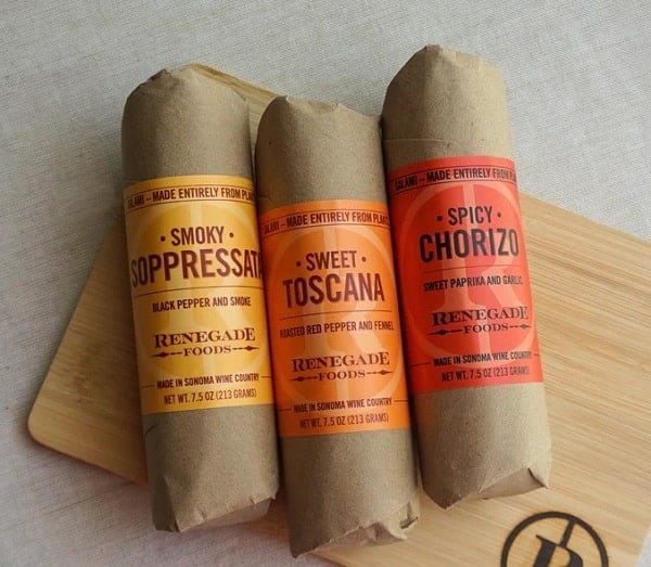 three vegan salami products wrapped in light brown packaging from renegade foods