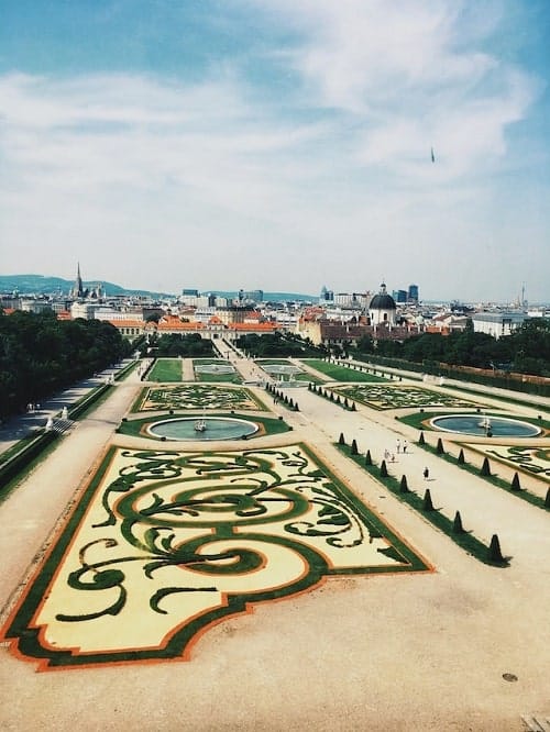 ornate green and yellow gardens with swirl pattens at belvedere palace in vienna