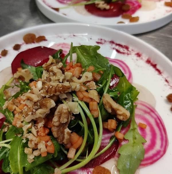vegan beet salad with chopped walnuts and baby spinach at hash tag foods in bruges
