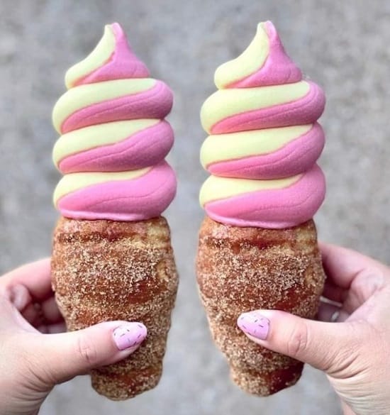 two vegan chimney cake cones filled with pineapple and strawberry dole whip from the house of chimney cakes in detroit