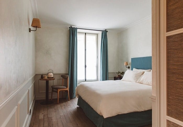 inside of a double hotel room with neutral colors at the vegan hotel HOY in paris