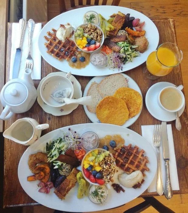 two large vegan breakfast plates filled with waffles, scramble and veggies at the judgy vegan brunch in brussels