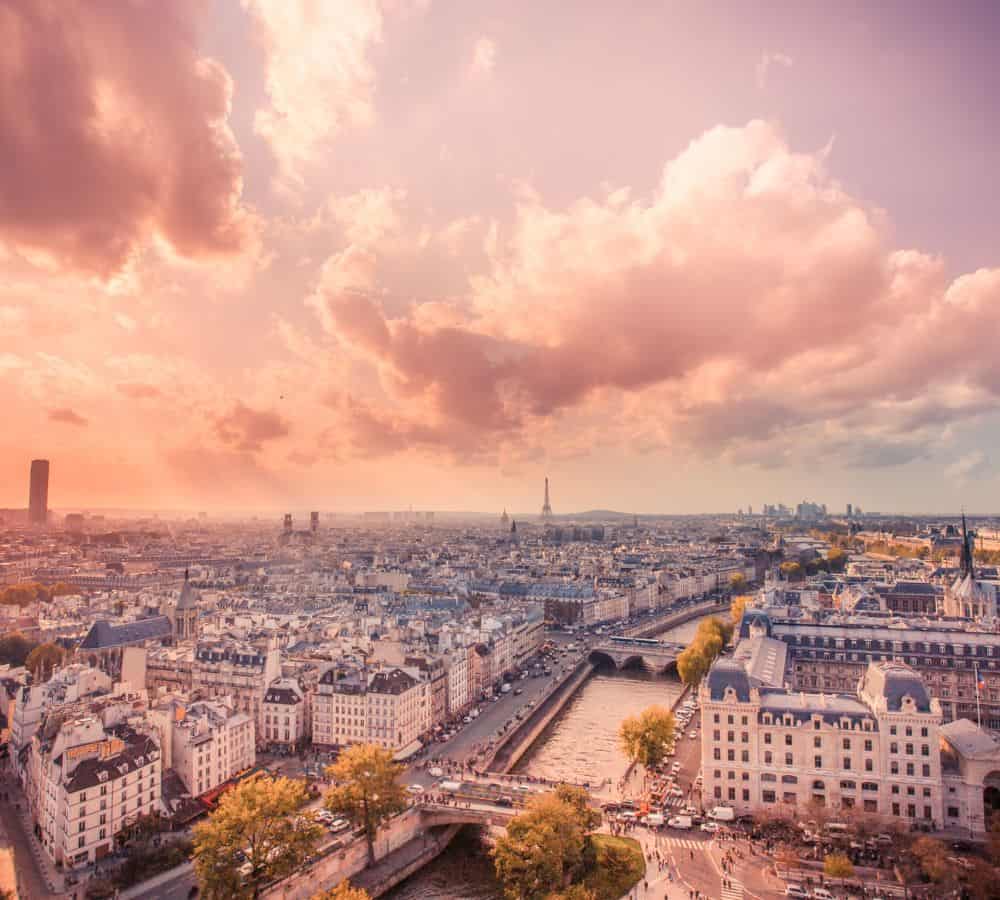 overhead view of paris at sunset with a pink sky setting on the city