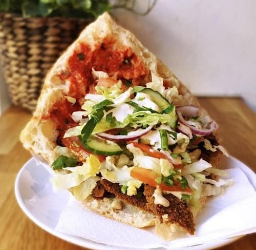 vegan doner sandwich with fluffy pita bread on a white plate at voner in berlin