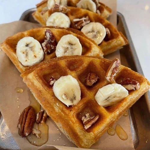 vegan waffles topped with sliced bananas and pecans from botanicals in new orleans
