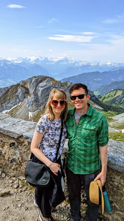 rebecca gade and matt sawicki on mount pilatus with the alps in the background on a partly cloudy day