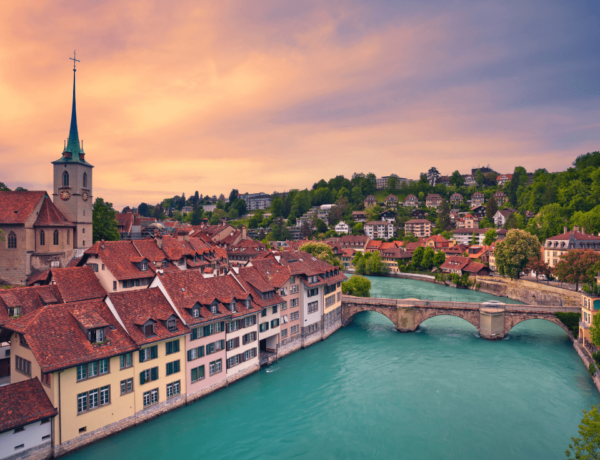 bern skyline at dusk with blue aare river and church in the background