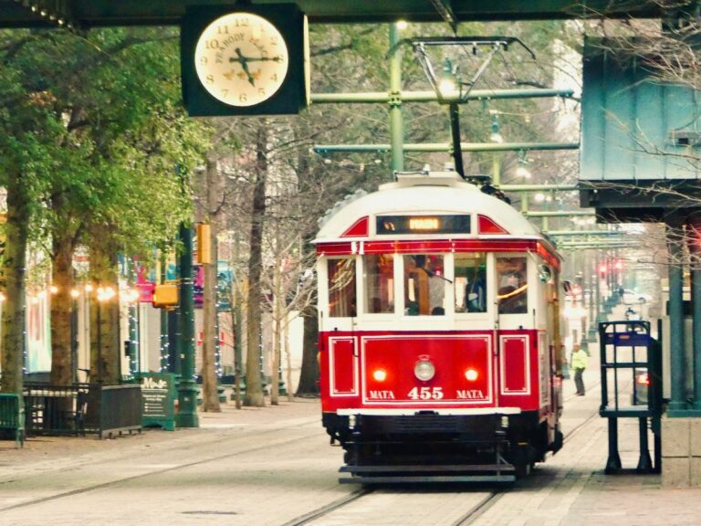 a single red trolly car coming down main street in memphis, TN