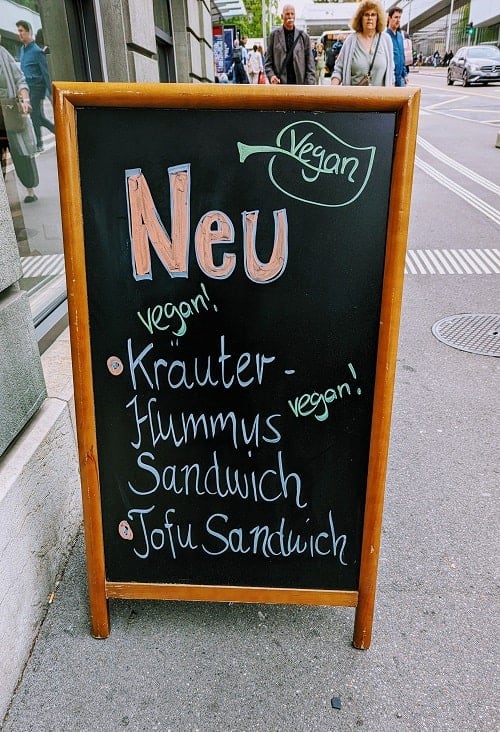 restaurant sign in bern promoting new vegan dishes