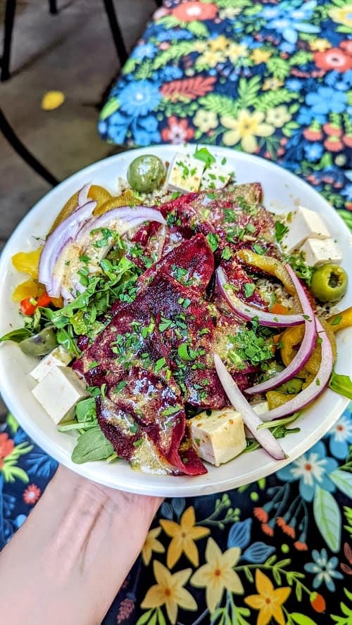 vegan antipasti bowl with cured tofu cubes, beets, herbs, olives, and dressing at dc vegan
