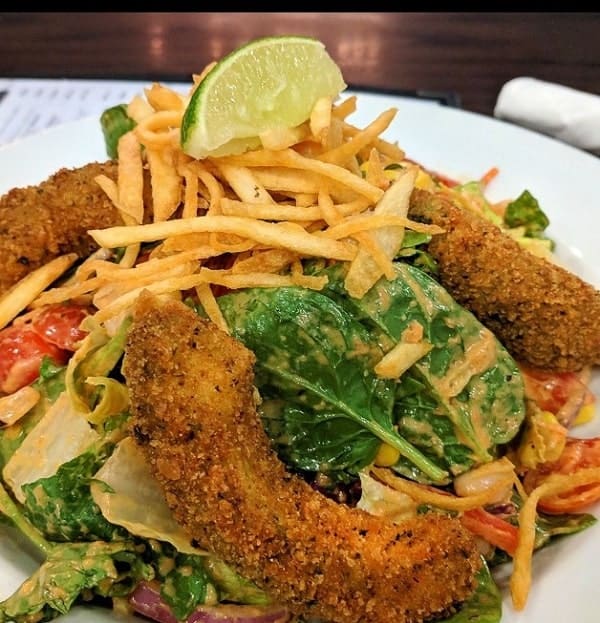 fried vegan chicken on a salad with cheese at chicago diner 