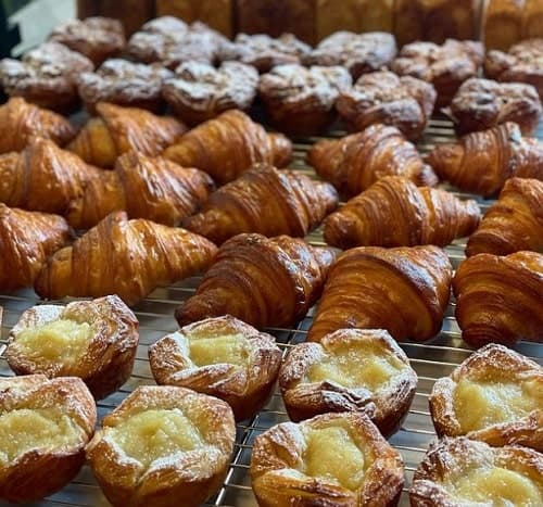 rows of golden vegan croissants and tarts from the bakery frea in berlin