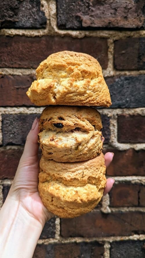 three vegan biscuits stacked on top of each other in front of bricks