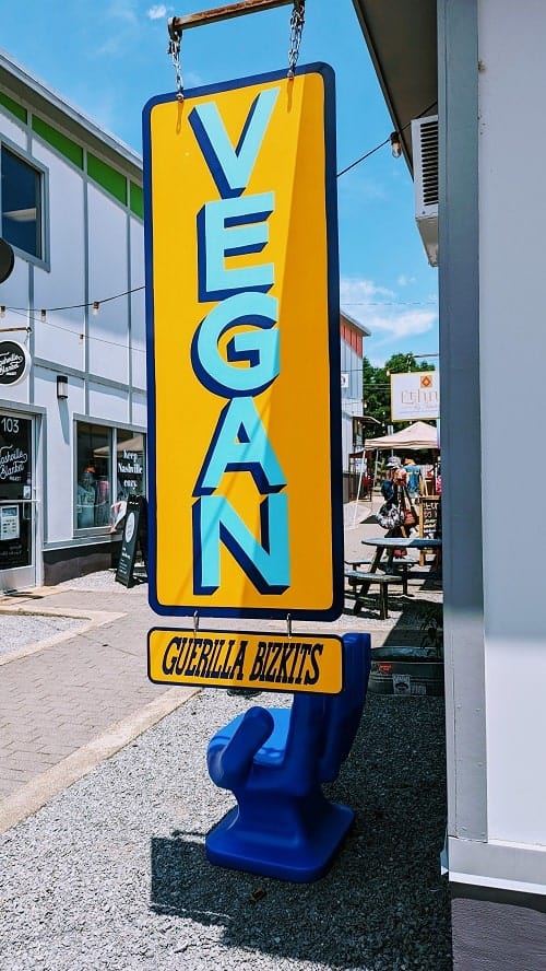 guerrilla bizkits blue and orange vegan sign in front of their shop in nashville