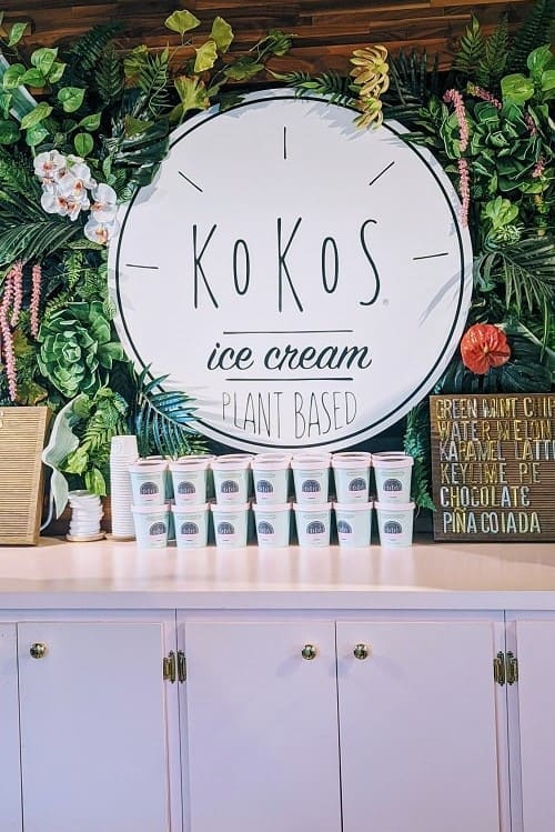 kokos plant based ice cream logo surrounded by greenery and flowers