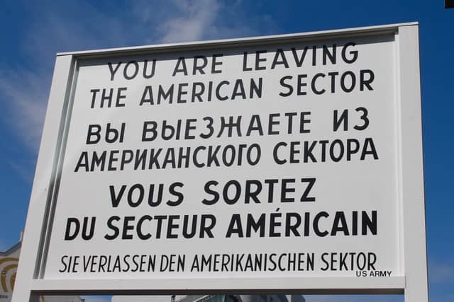 check point charlie white sign with black writing in berlin