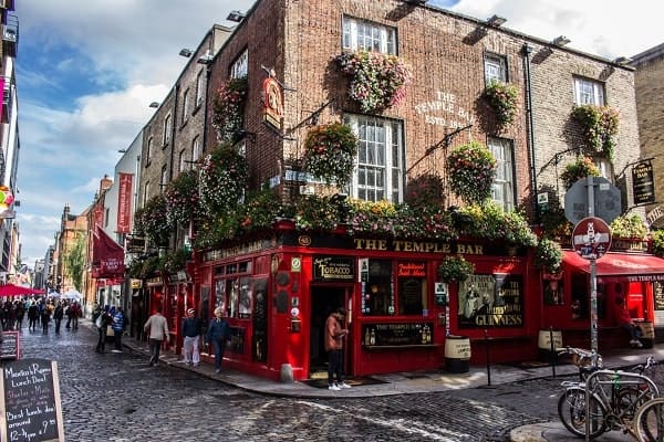 bright red temple bar with green hanging baskets in dublin