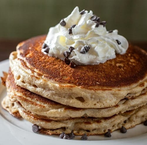 chicago diner stack of vegan chocolate chip pancakes topped with a mound of whipped cream