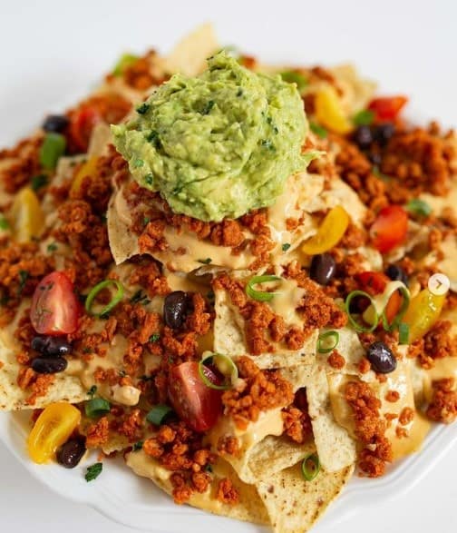 loaded vegan nachos topped with guac from uptowns in chicago