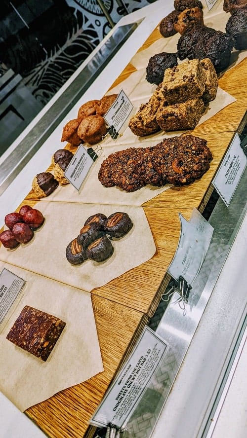 vegan and gluten free baked good and raw treats lined up in a display case from kupert & kim in toronto