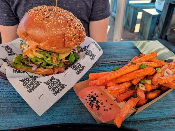 vegan junk food bar in amsterdam giant veggie burger with cheese and crispy sweet potato fries