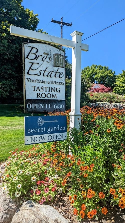 brys estate entrance sign in the middle of a flower garden in traverse city