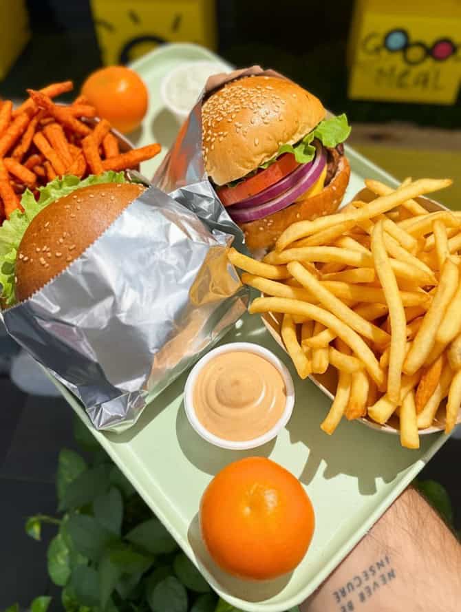 two vegan burger with french fries on a light green tray at cocinita in miami