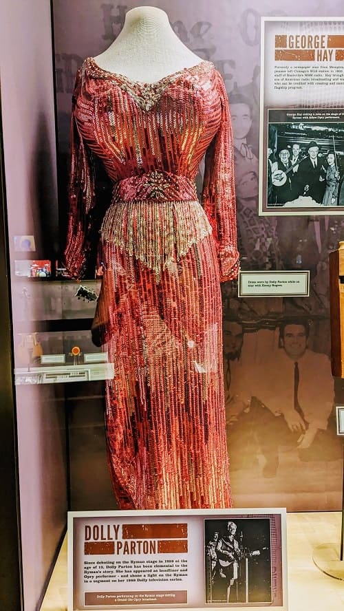 pink, sequin dress behind glass worn by dolly parton at the ryman auditorium in nashville