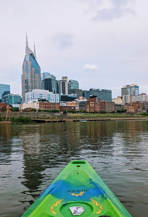 kayaking on the cumberland river in nashville on a partly cloudy day with views of downtown