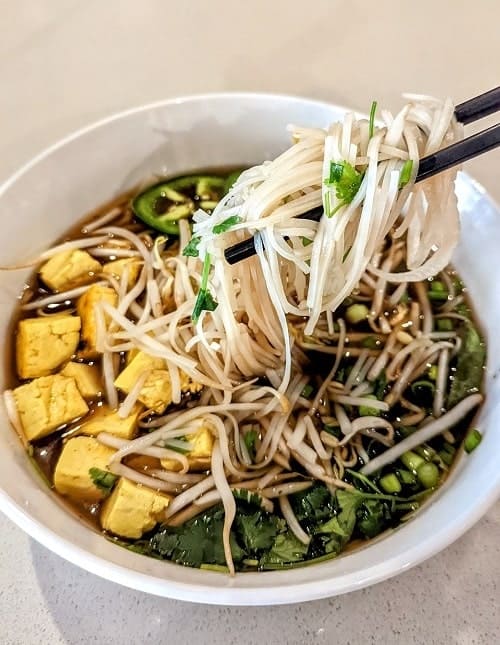 bowl of vegan pho with tumeric tofu from the good bowl in traverse city