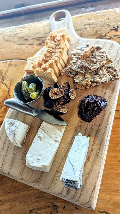 vegan cheese board with three kinds of cheese and jam, figs, and crackers at atwater vineyards in finger lakes