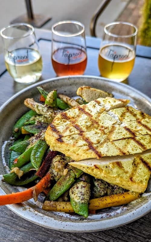 vegan yogi bowl with fresh veggies and topped with grilled tofu and a flight of hard ciders at taproot in traverse city
