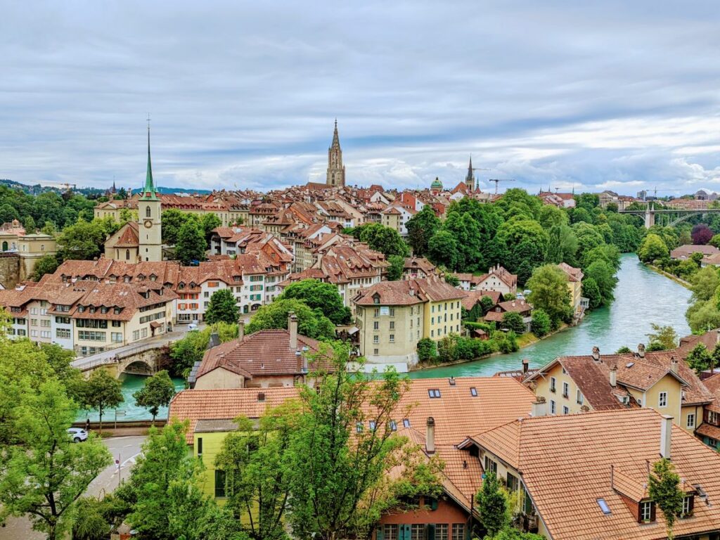 overhead view of the charming town of bern with a vibrant blue river flowing through the middle on a cloudy day