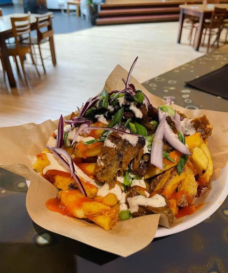 loaded vegan french fries covered in seitan meat, cream sauce and hot sauce in glasgow