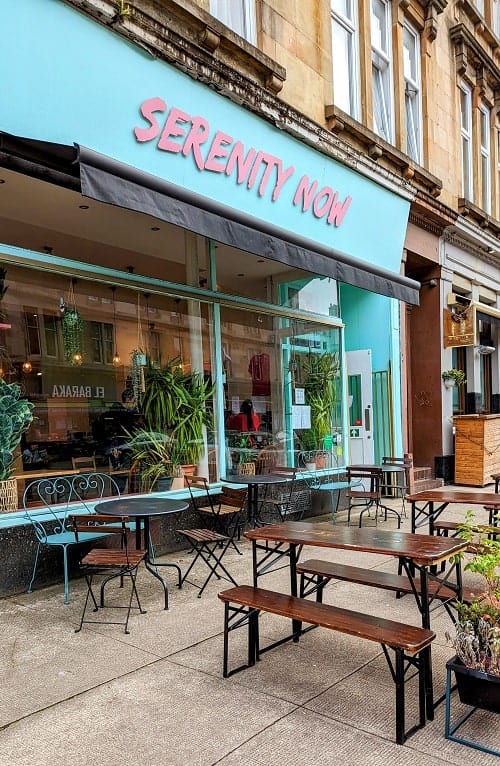 the blue outside of the vegan cafe serenity now written in pink in glasgow