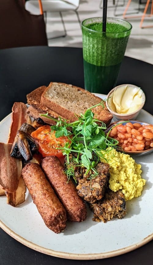 full vegan and gluten free scottish breakfast with sausage, toast, haggis, tomatoes at oly cow in edinburgh