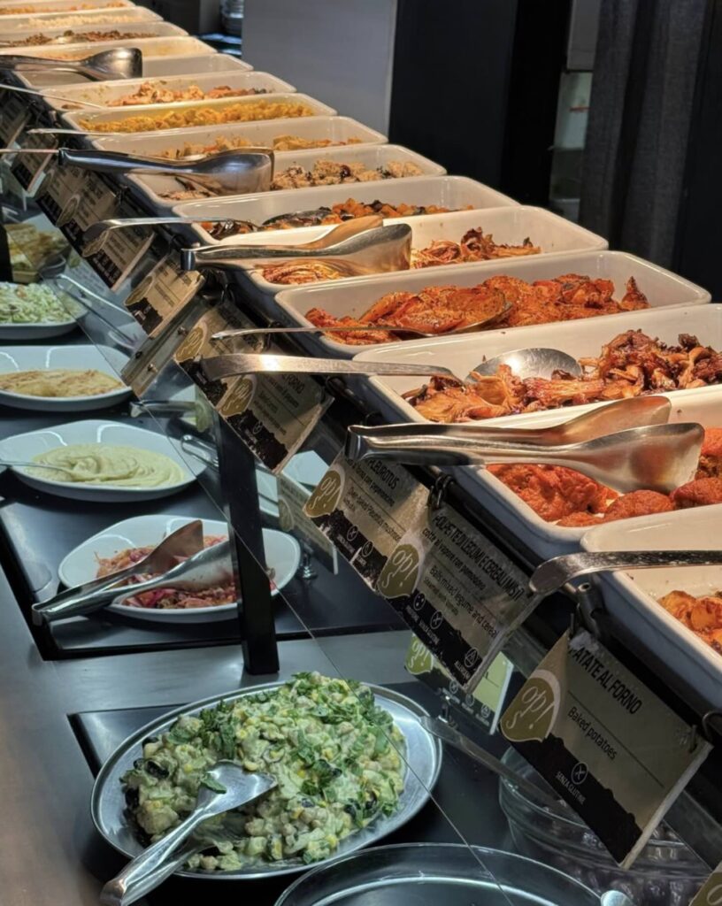 Vegan Buffet with multiple dishes aligned on deep ceramic plates.