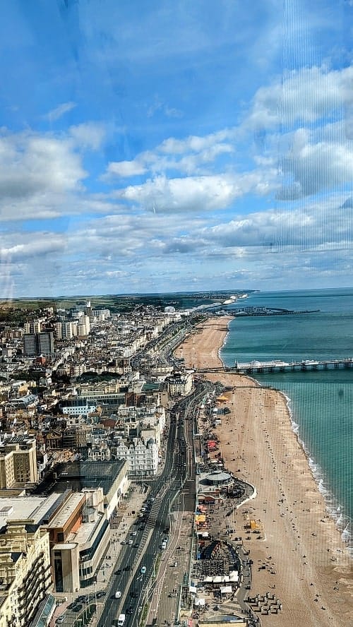 view of the brighton seafront on a bright and sunny day from the i360 ride on the brighton waterfront