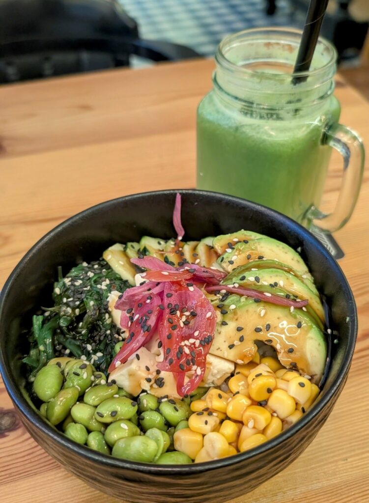 vegan tofu poke bowl with edamame and seaweed with a green smoothie at celioso gluten free cafe inside the only you boutique hotel in madrid