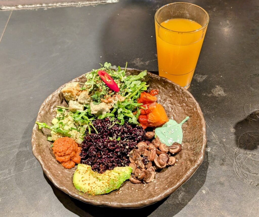 vegan Mediterranean salad bowl with tofu, sweet potatoes, black rice and colorful veggies at honest greens in madrid