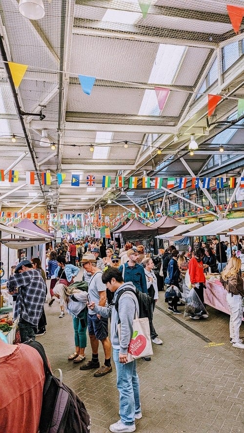 inside of the bustling open market in brighton filled with many people