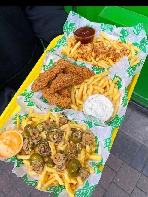 three basked of vegan french fries, chicken tenders , and loaded french fries with cheese and jalapenos in brighton