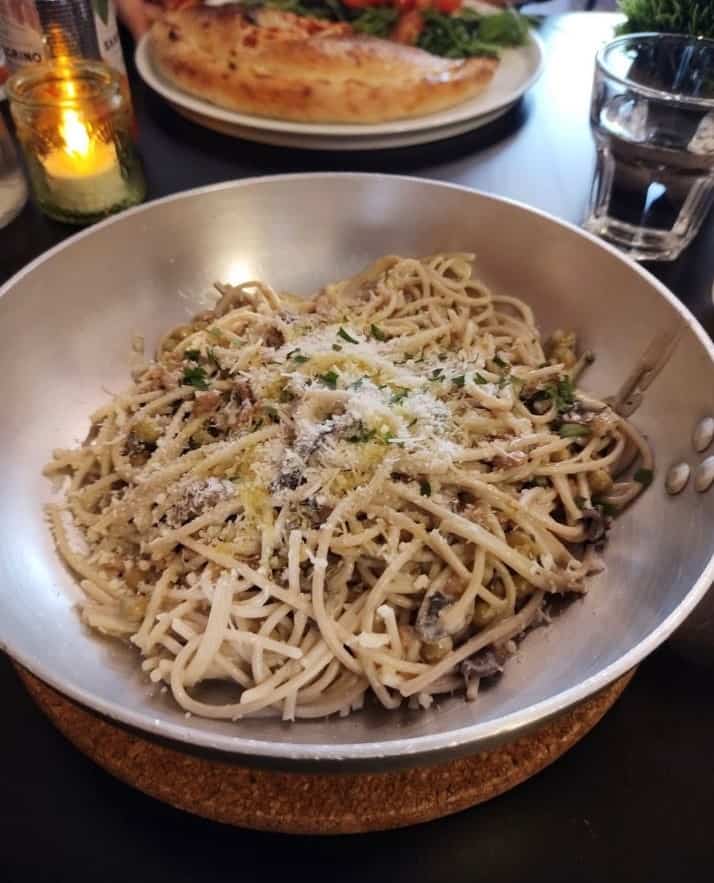 a round bowl of vegan cream covered pasta with spaghetti noodles in edinburgh