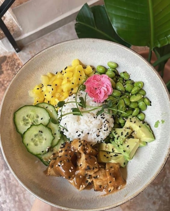 colorful vegan bowl with tumeric rice, tofu, edamame, and more in krakow