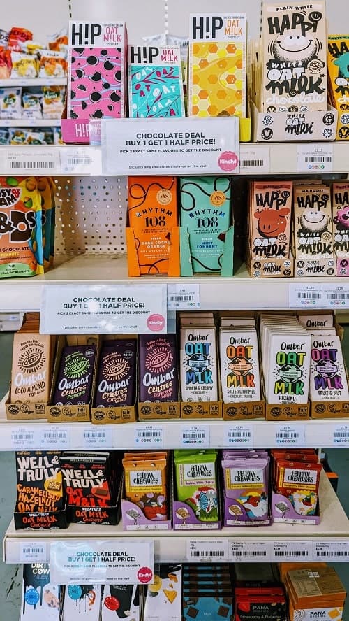 multiple white shelves filled with vegan chocolate bars in brighton