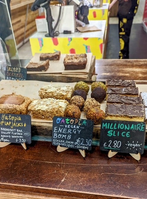 small dessert case filled with a variety of baked, raw and vegan desserts at super market rebels in brighton