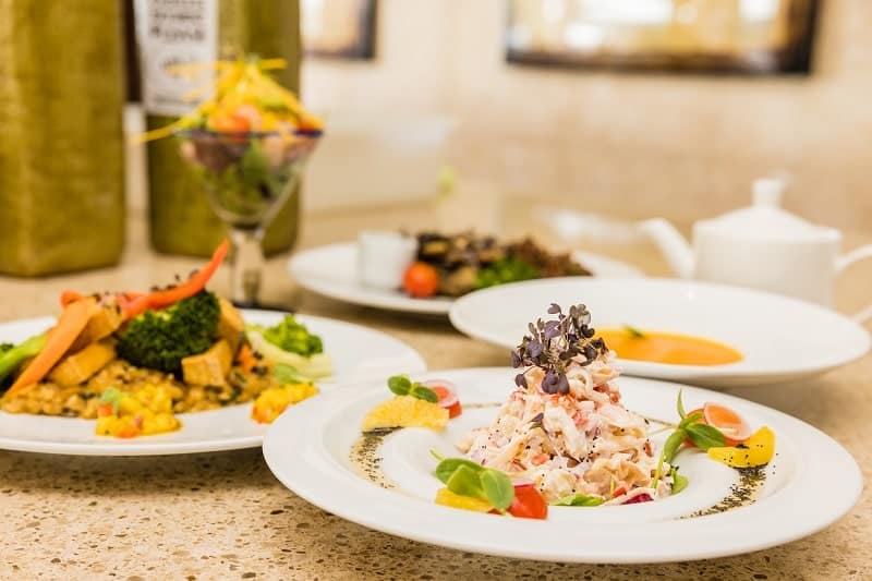 three vegan dining options on large round white plates at manchebo beach resort in aruba